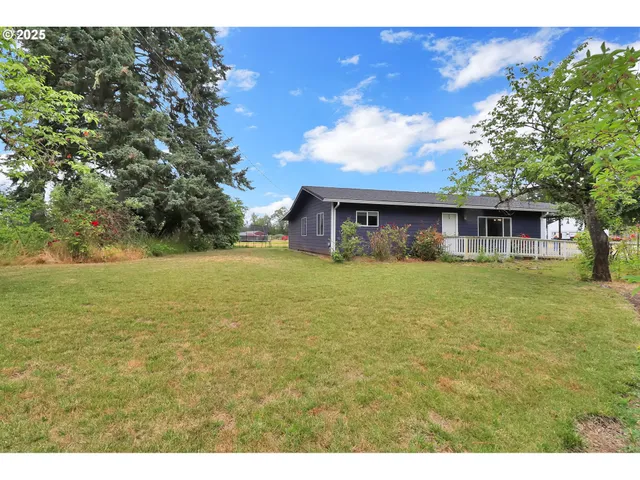 a front view of house with yard and trees