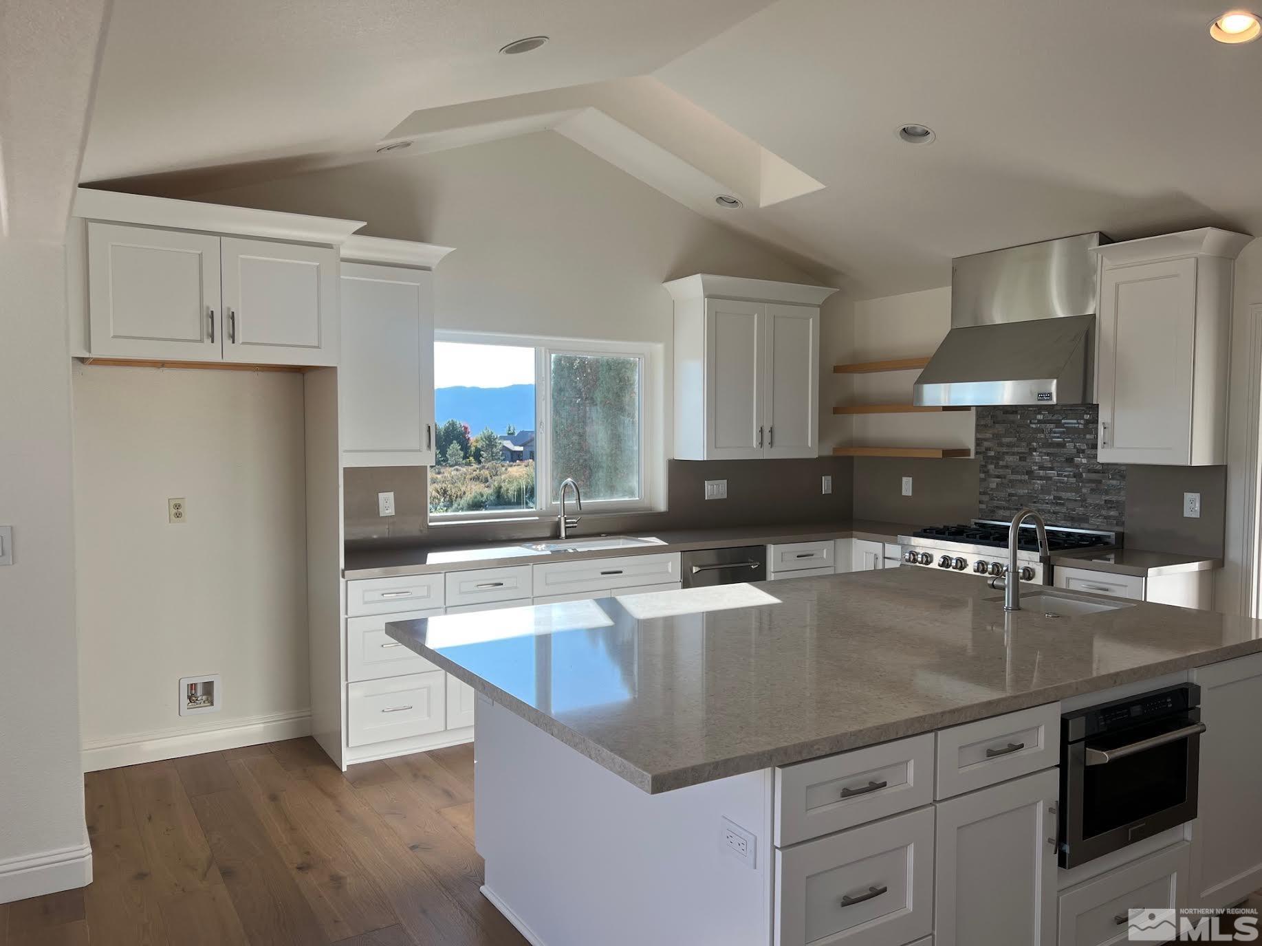 14230 Prairie Flower Court Reno, NV 89511 - Photo 12 of 39 a kitchen with stainless steel appliances granite countertop a sink a stove and a refrigerator