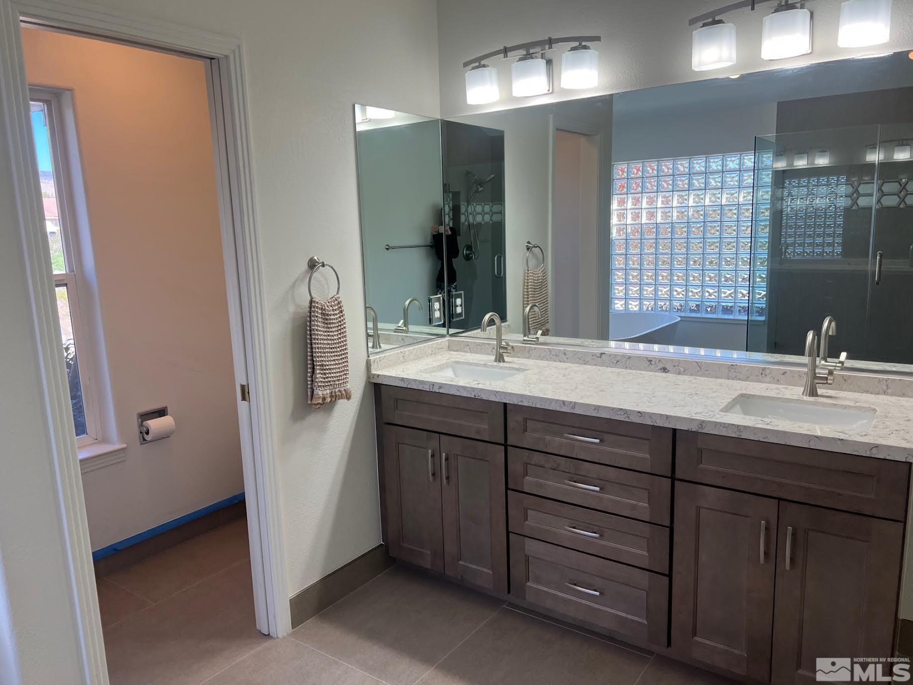 14230 Prairie Flower Court Reno, NV 89511 - Photo 15 of 39 a bathroom with a double vanity sink double and mirror