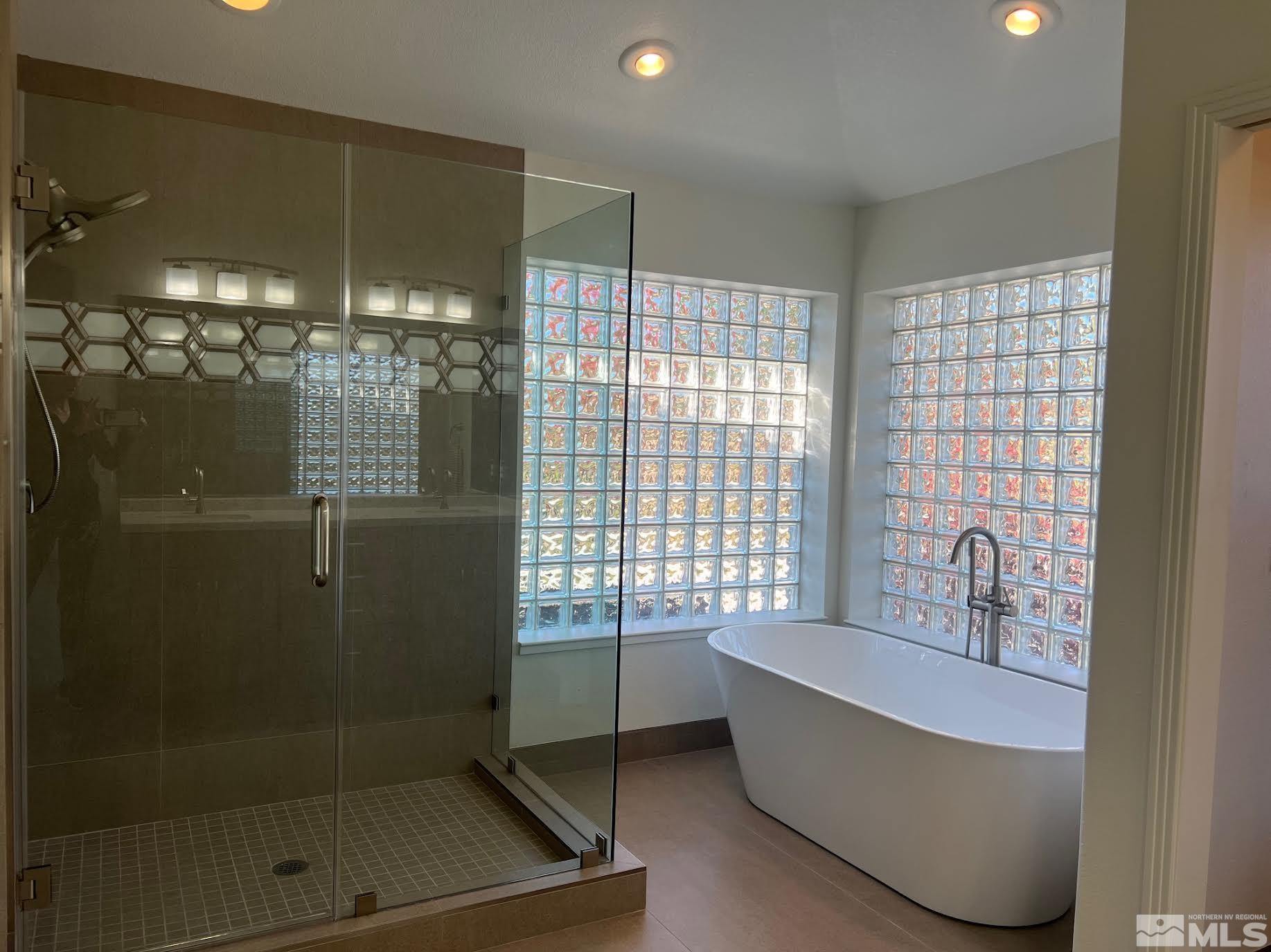 14230 Prairie Flower Court Reno, NV 89511 - Photo 17 of 39 a bathroom with a bathtub and shower