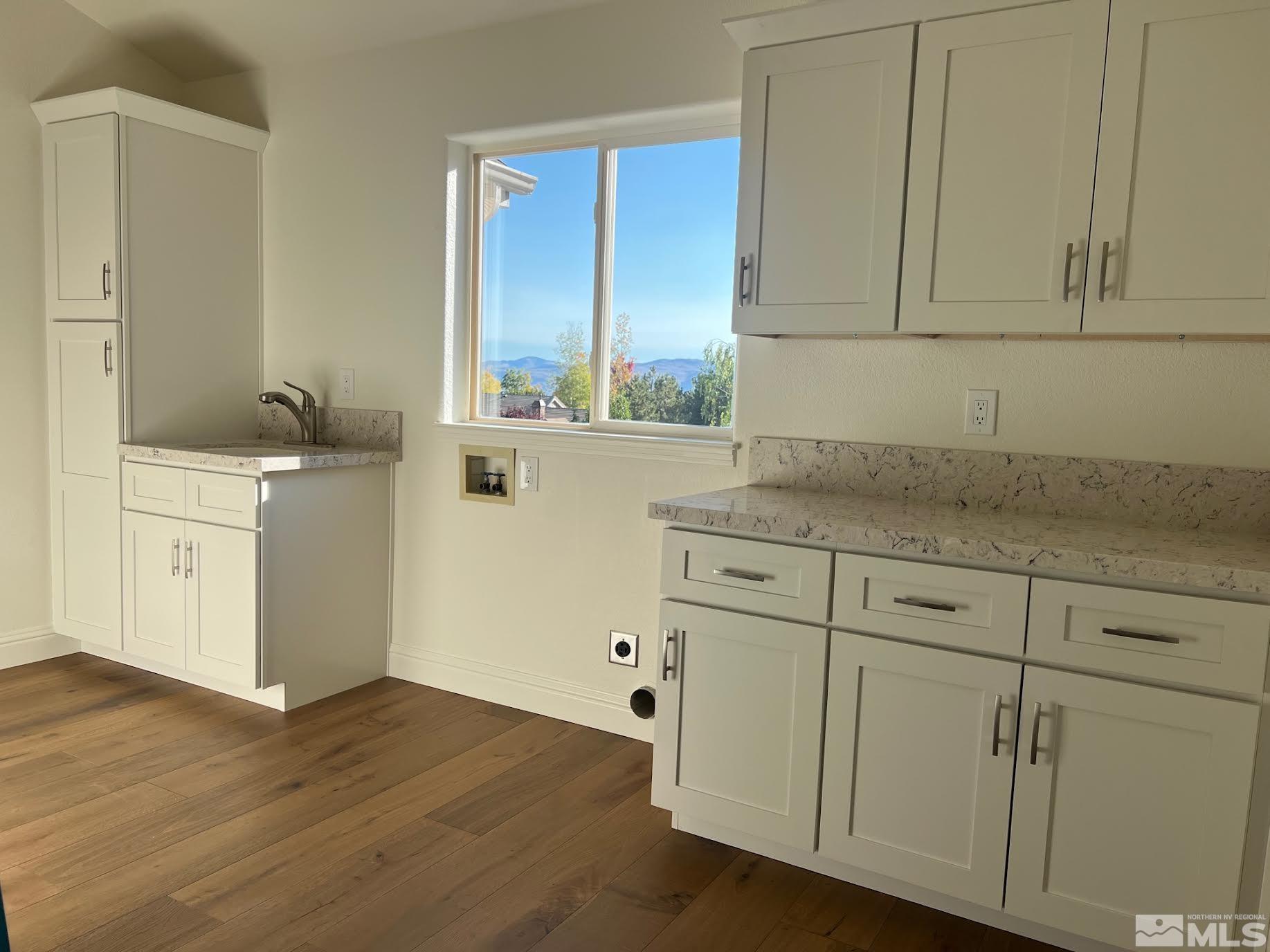 14230 Prairie Flower Court Reno, NV 89511 - Photo 23 of 39 a kitchen with granite countertop white cabinets and white appliances