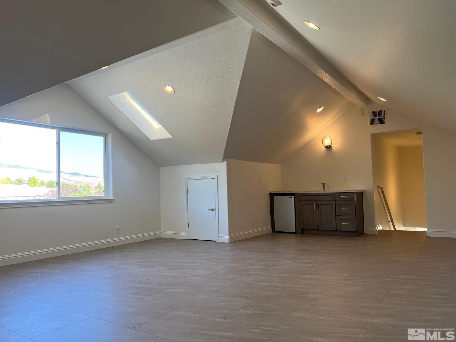 14230 Prairie Flower Court Reno, NV 89511 - Photo 32 of 39 an empty room with windows and cabinet