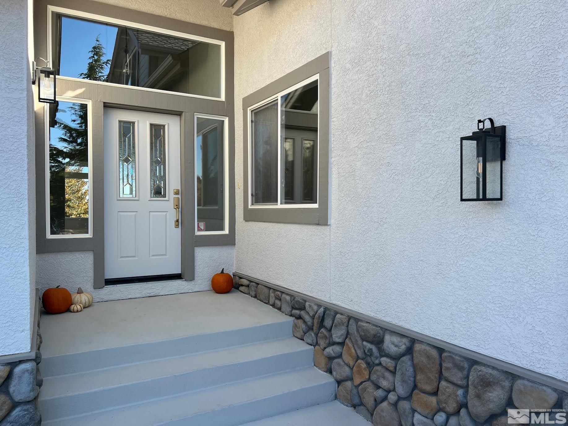 14230 Prairie Flower Court Reno, NV 89511 - Photo 4 of 39 a view of an entryway with wooden floor