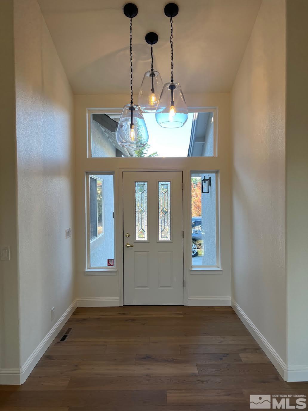 14230 Prairie Flower Court Reno, NV 89511 - Photo 5 of 39 an empty room with wooden floor and windows