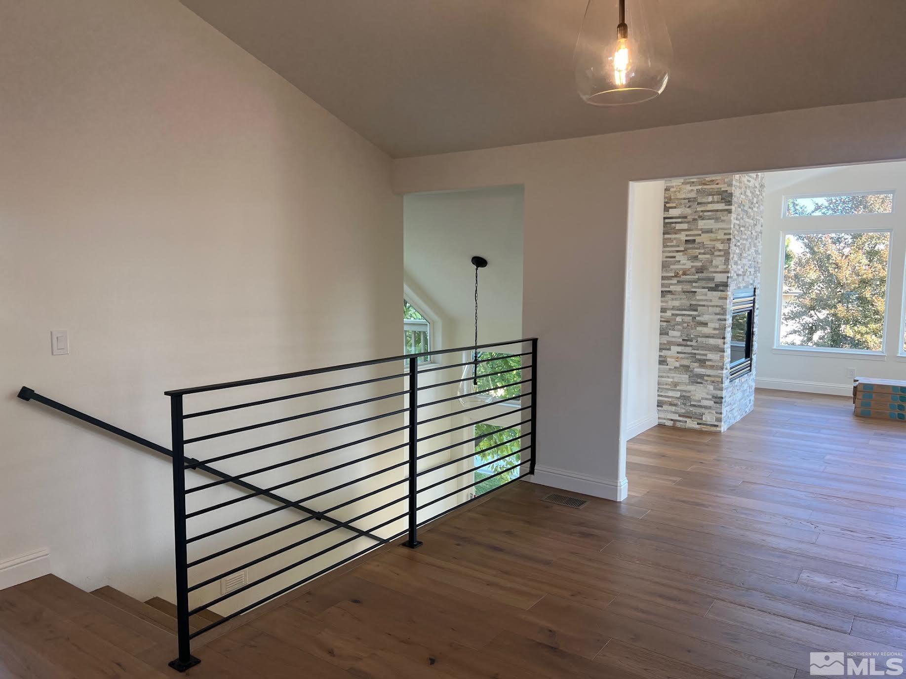 14230 Prairie Flower Court Reno, NV 89511 - Photo 6 of 39 a view of a hallway with wooden floor and stairs