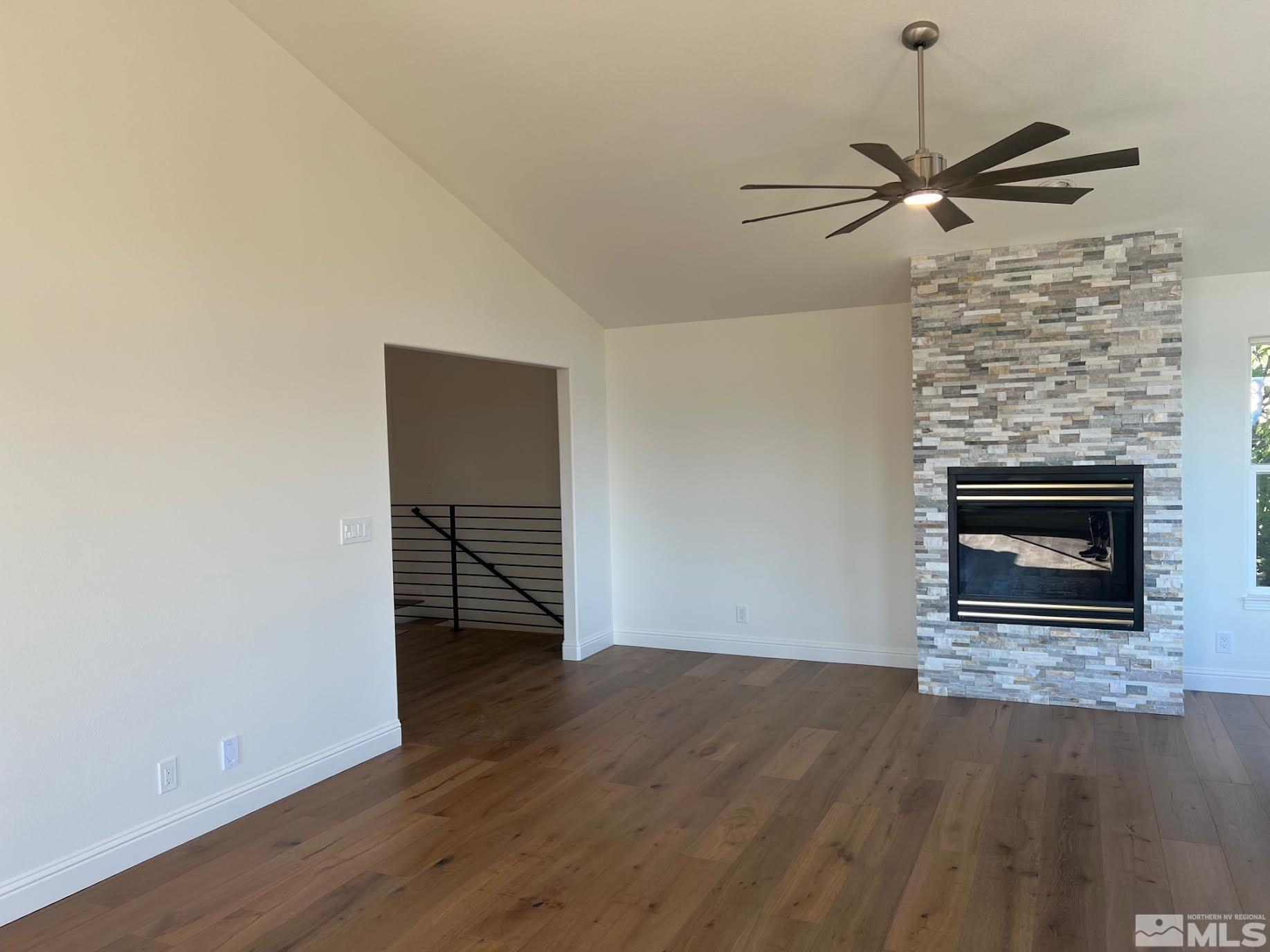 14230 Prairie Flower Court Reno, NV 89511 - Photo 8 of 39 a view of empty room with wooden floor and fireplace