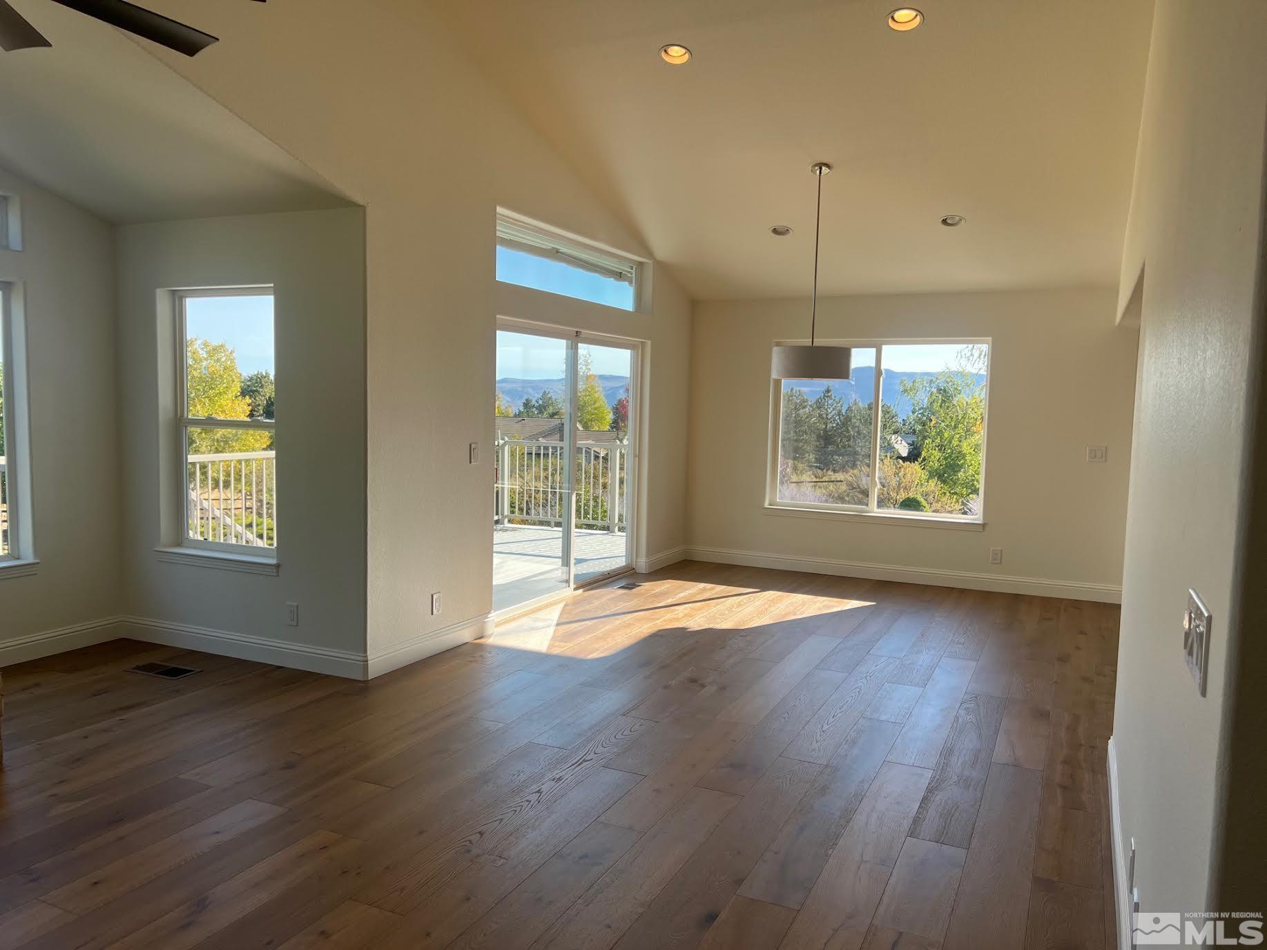 14230 Prairie Flower Court Reno, NV 89511 - Photo 9 of 39 an empty room with wooden floor and windows