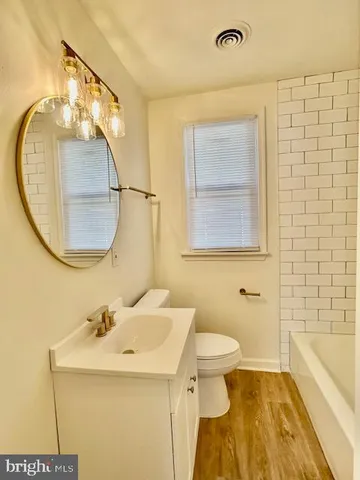a bathroom with a sink a mirror and a toilet