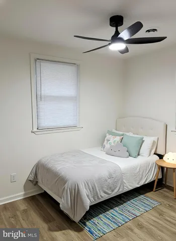 a bedroom with a bed and a night stand