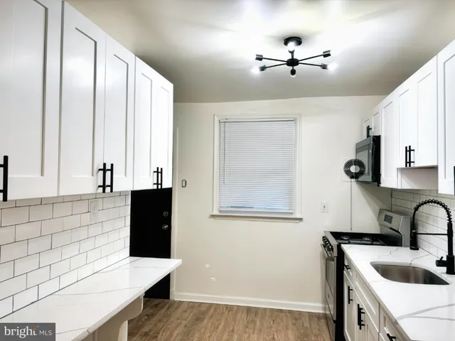 a kitchen with a sink cabinets and window