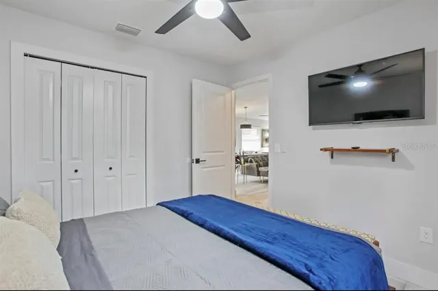 a bedroom with furniture and a flat screen tv