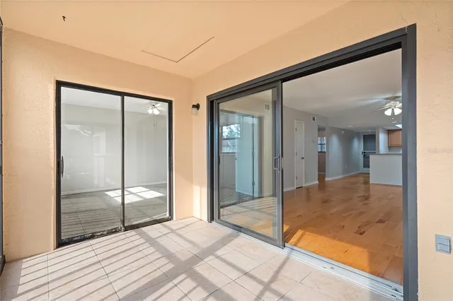 a view of a hallway with wooden floor and glass door