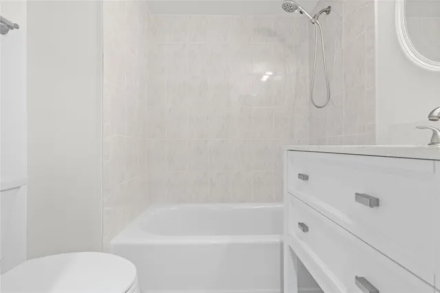 a bathroom with a shower a toilet and sink