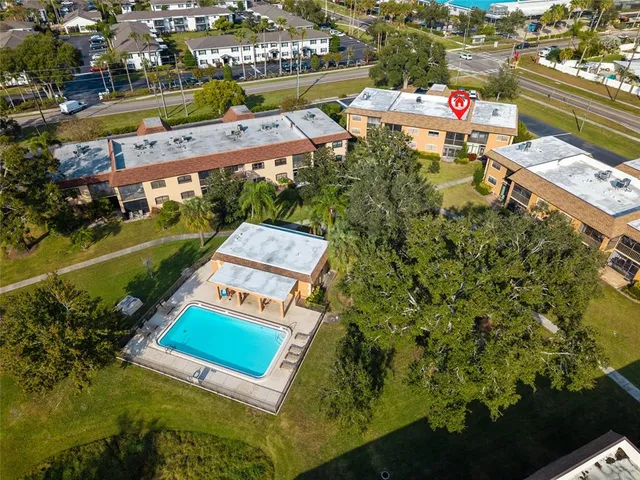 an aerial view of a house with a garden and lake view