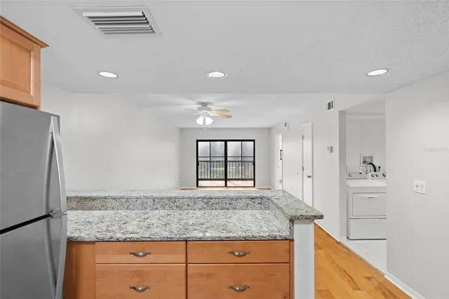 a bathroom with a granite countertop sink a large mirror and a window