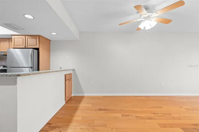 a view of a kitchen with a sink and a refrigerator