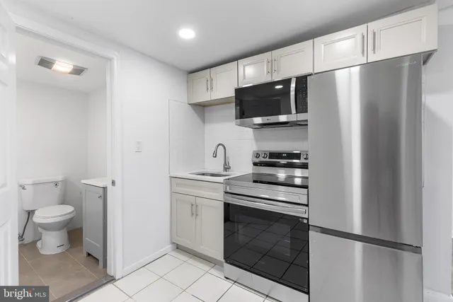 a kitchen with stainless steel appliances a refrigerator stove and microwave