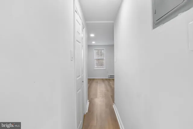a view of a hallway with wooden floor