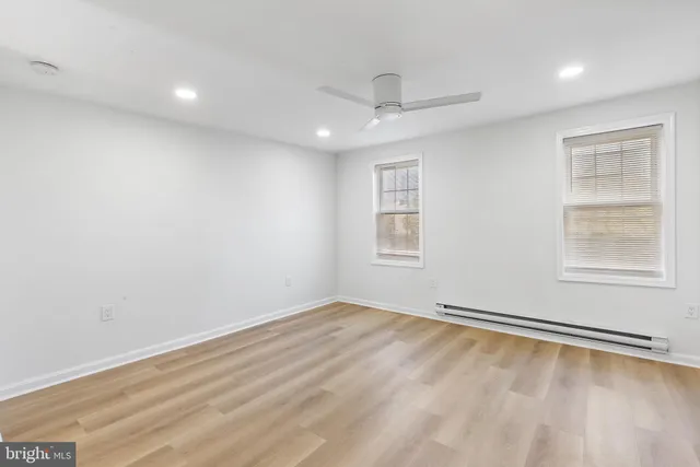 a white toilet sitting next to a bath tub