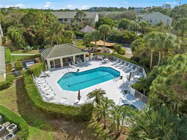 an aerial view of residential houses with outdoor space and pool