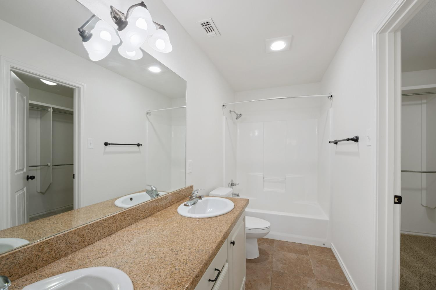 6816 Oakridge Avenue Lubbock, TX 79424 - Photo 12 of 19 a bathroom with a granite countertop sink a toilet and shower