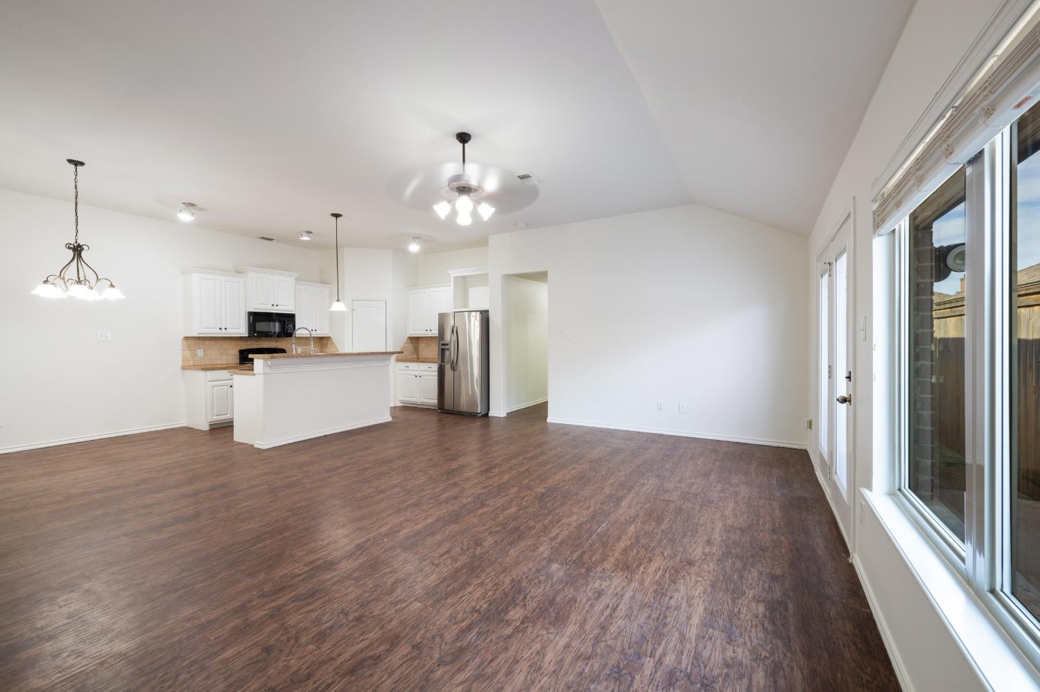 6816 Oakridge Avenue Lubbock, TX 79424 - Photo 6 of 19 a view of a kitchen with a sink dishwasher a refrigerator and wooden floor