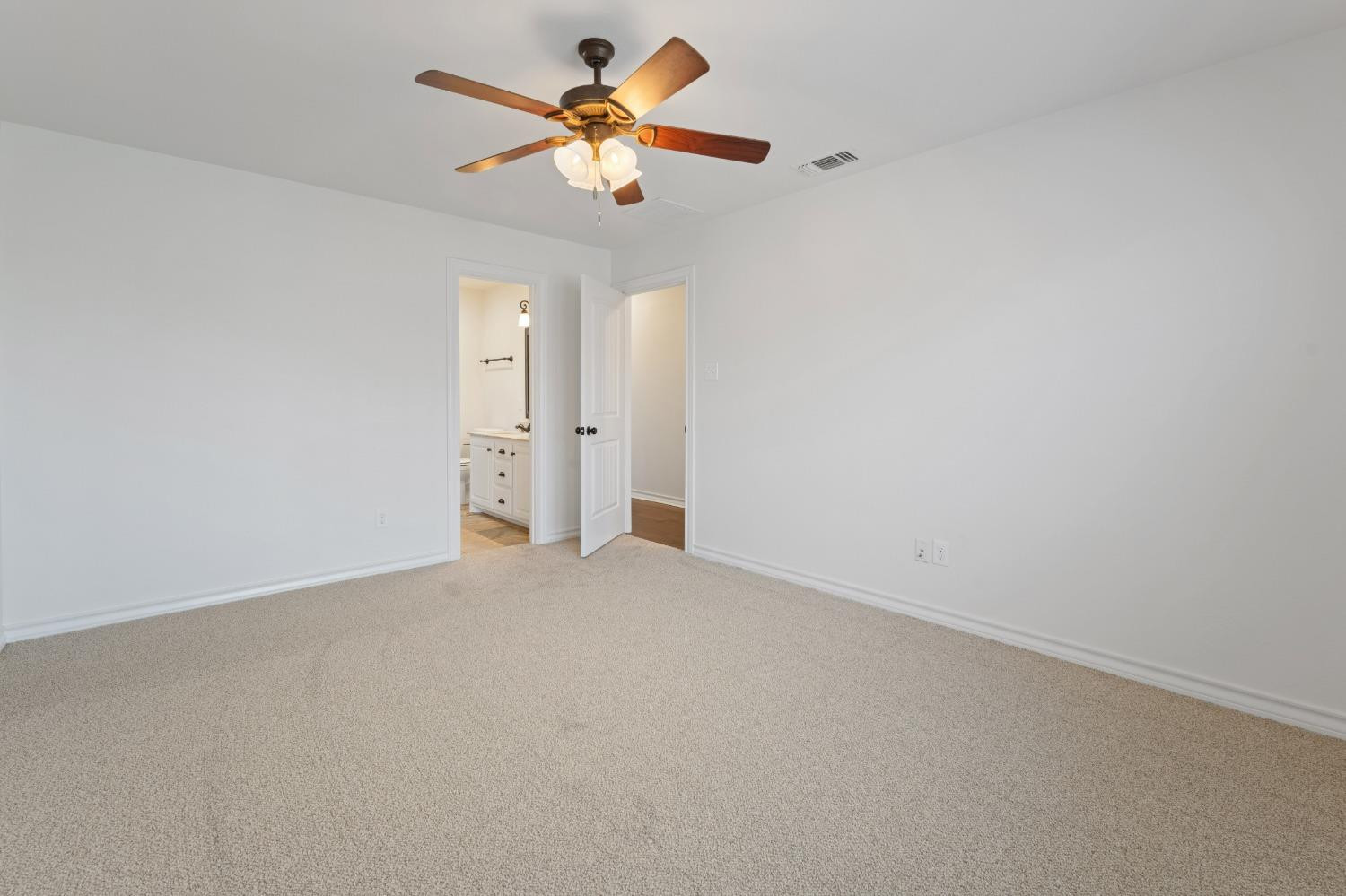 6816 Oakridge Avenue Lubbock, TX 79424 - Photo 8 of 19 an empty room with a chandelier fan and windows