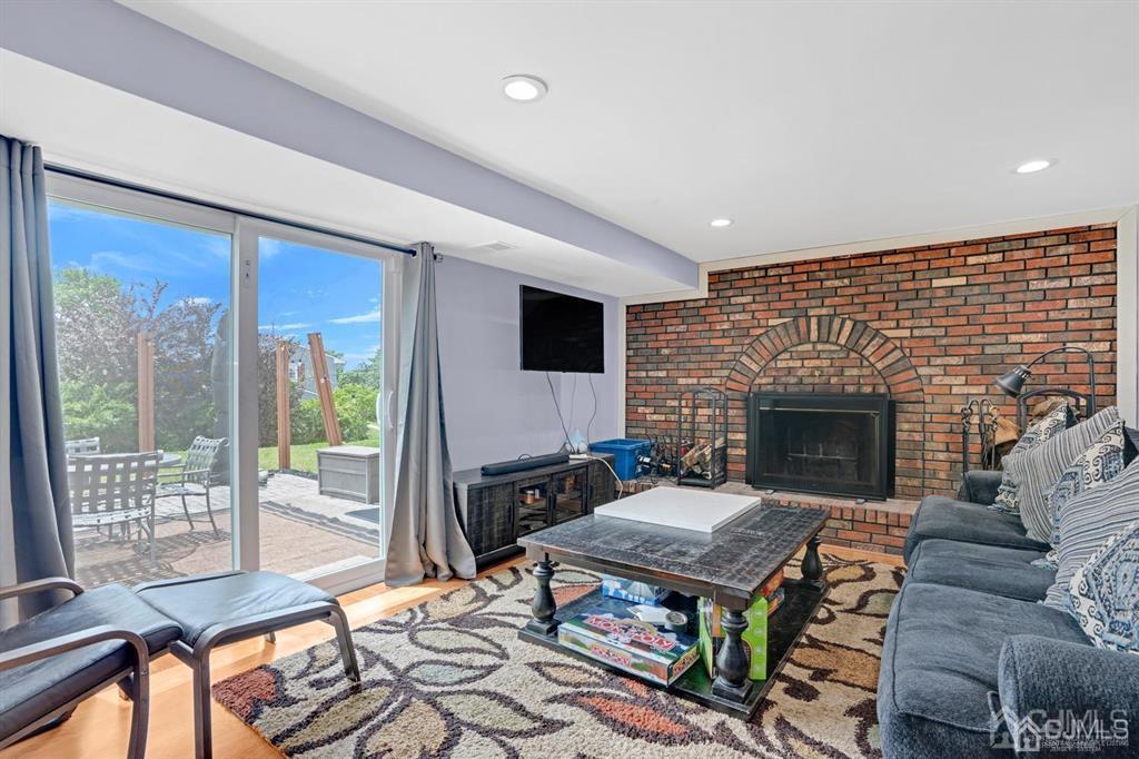 23 Vauxhall Road East Brunswick, NJ 08816 - Photo 12 of 28 a living room with furniture and a fireplace