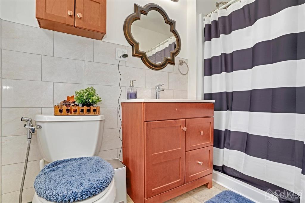23 Vauxhall Road East Brunswick, NJ 08816 - Photo 14 of 28 a bathroom with a sink and a mirror