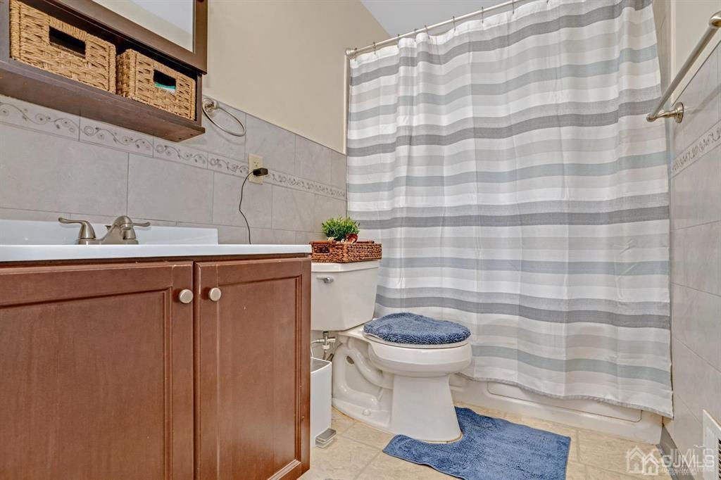 23 Vauxhall Road East Brunswick, NJ 08816 - Photo 16 of 28 a bathroom with a sink toilet and a mirror