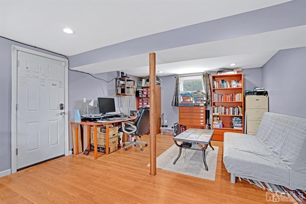 23 Vauxhall Road East Brunswick, NJ 08816 - Photo 18 of 28 a living room with furniture and a flat screen tv