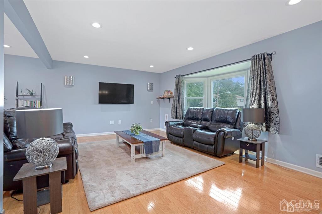 23 Vauxhall Road East Brunswick, NJ 08816 - Photo 20 of 28 a living room with furniture and a flat screen tv