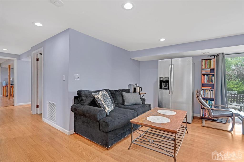 23 Vauxhall Road East Brunswick, NJ 08816 - Photo 24 of 28 a living room with furniture and a table