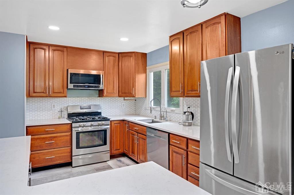 23 Vauxhall Road East Brunswick, NJ 08816 - Photo 4 of 28 a kitchen with stainless steel appliances granite countertop a refrigerator stove and sink