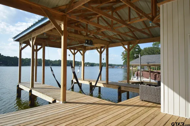 a view of a living room with wooden floor and iron stairs