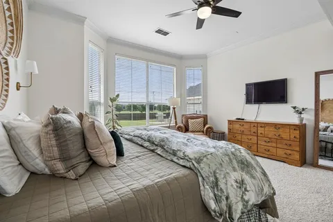 a bedroom with a bed and a flat screen television