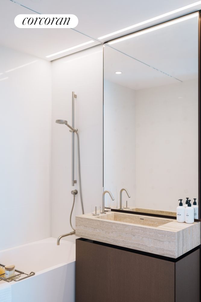 100 East 53rd Street, Unit 41B Manhattan, NY 10022 - Photo 12 of 25 a bathroom with a sink and mirror