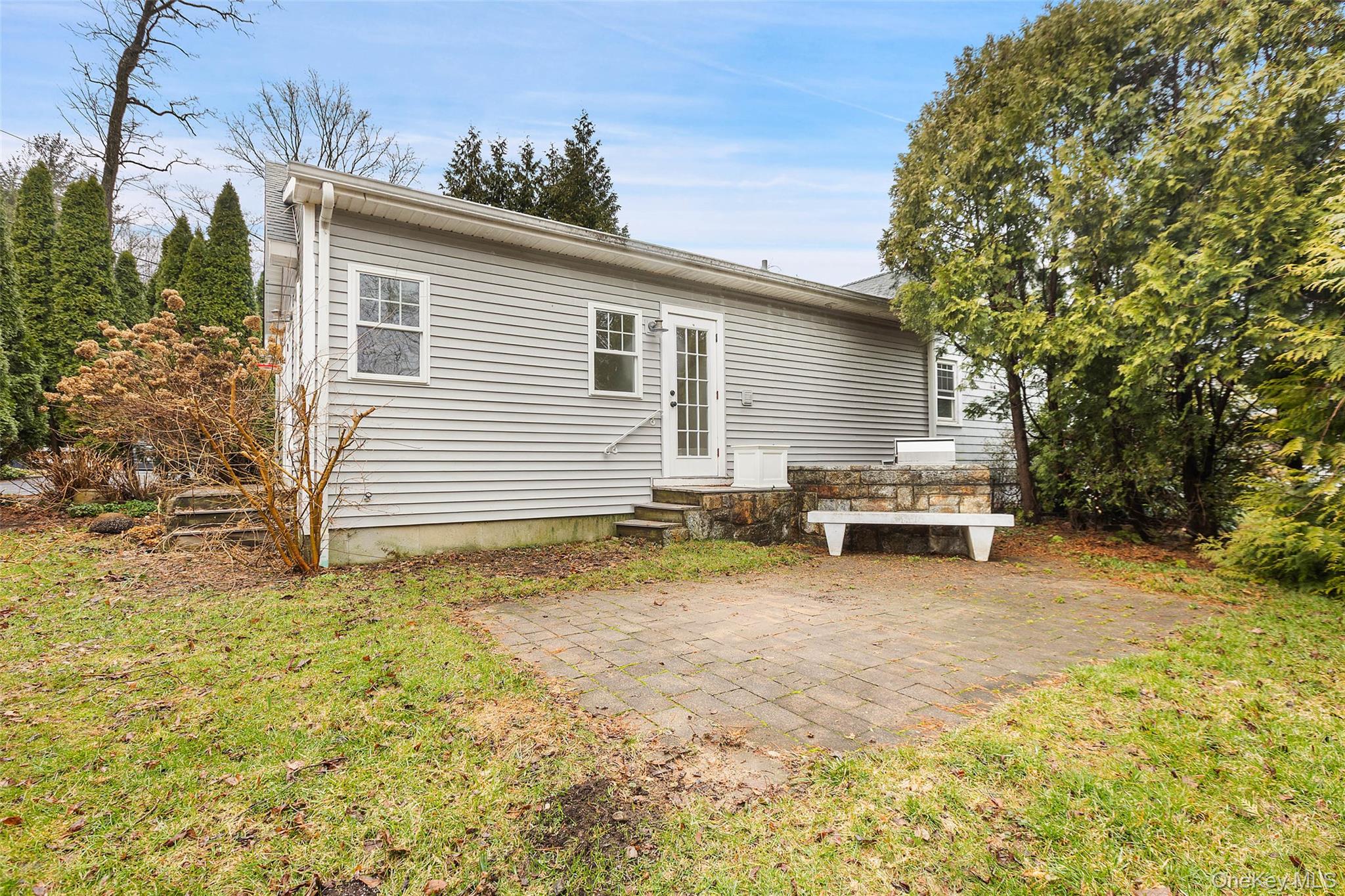 56 Huntville Road Katonah, NY 10536 - Photo 40 of 44 Side of house with Stone patio and outdoor stone kitchen.