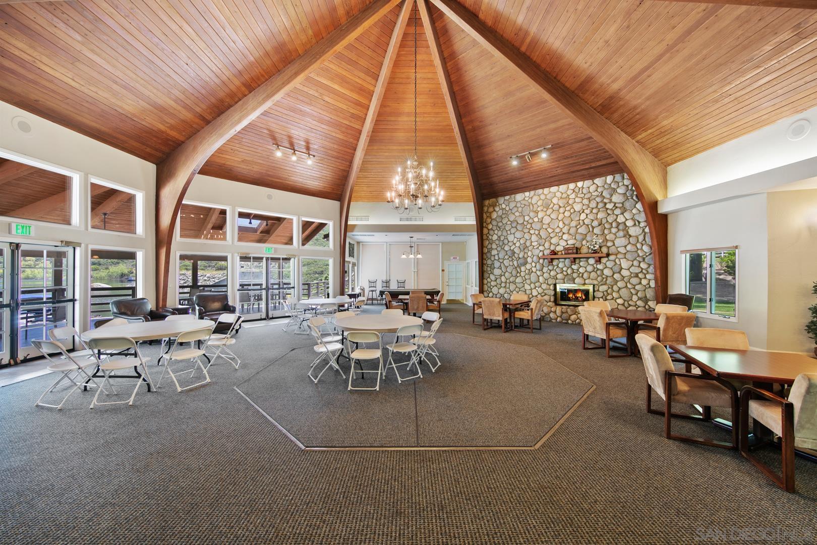 0 Via Viejas Oeste Alpine, CA 91901 - Photo 11 of 36 a living room with furniture a fireplace and large windows