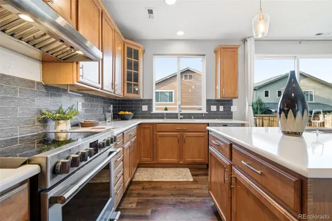 a kitchen with stainless steel appliances granite countertop a sink and a stove