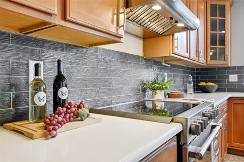 a kitchen with a table chairs sink and cabinets