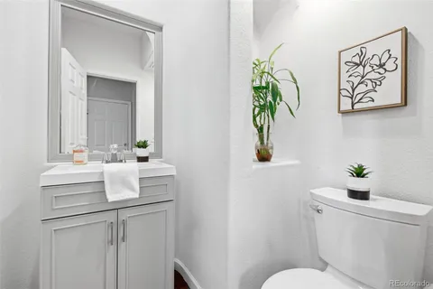 a bathroom with a granite countertop shower a mirror and a sink