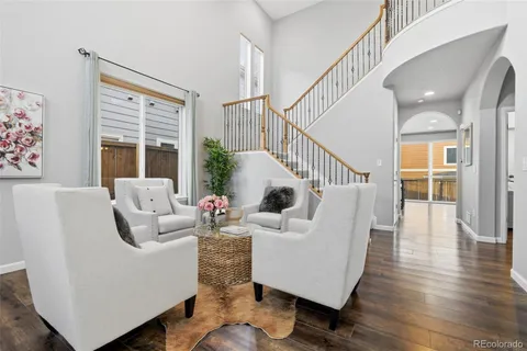 a living room with furniture and wooden floor