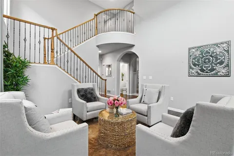 a living room with furniture and a chandelier