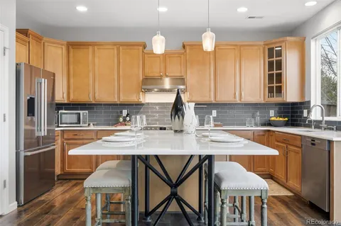 a kitchen with a table chairs sink and cabinets