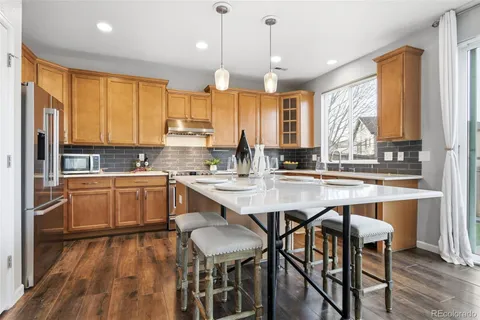 a kitchen with a table chairs sink and cabinets