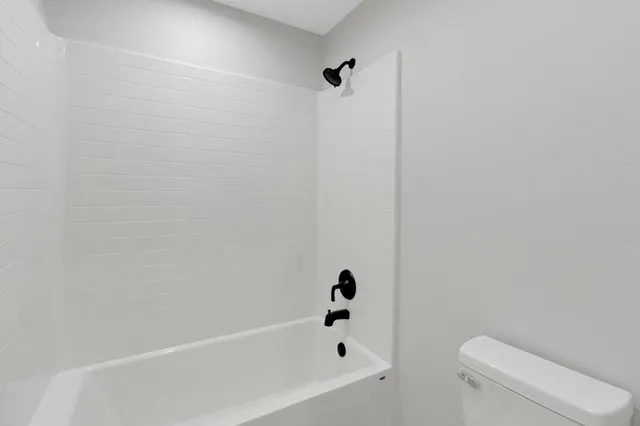 a bathroom with a bathtub and toilet