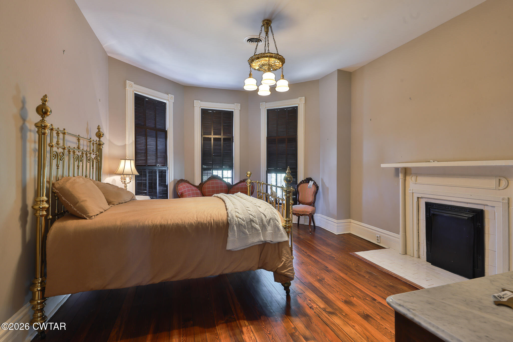 203 North McCombs Street Martin, TN 38237 - Photo 18 of 37 a bedroom with a bed and a chandelier