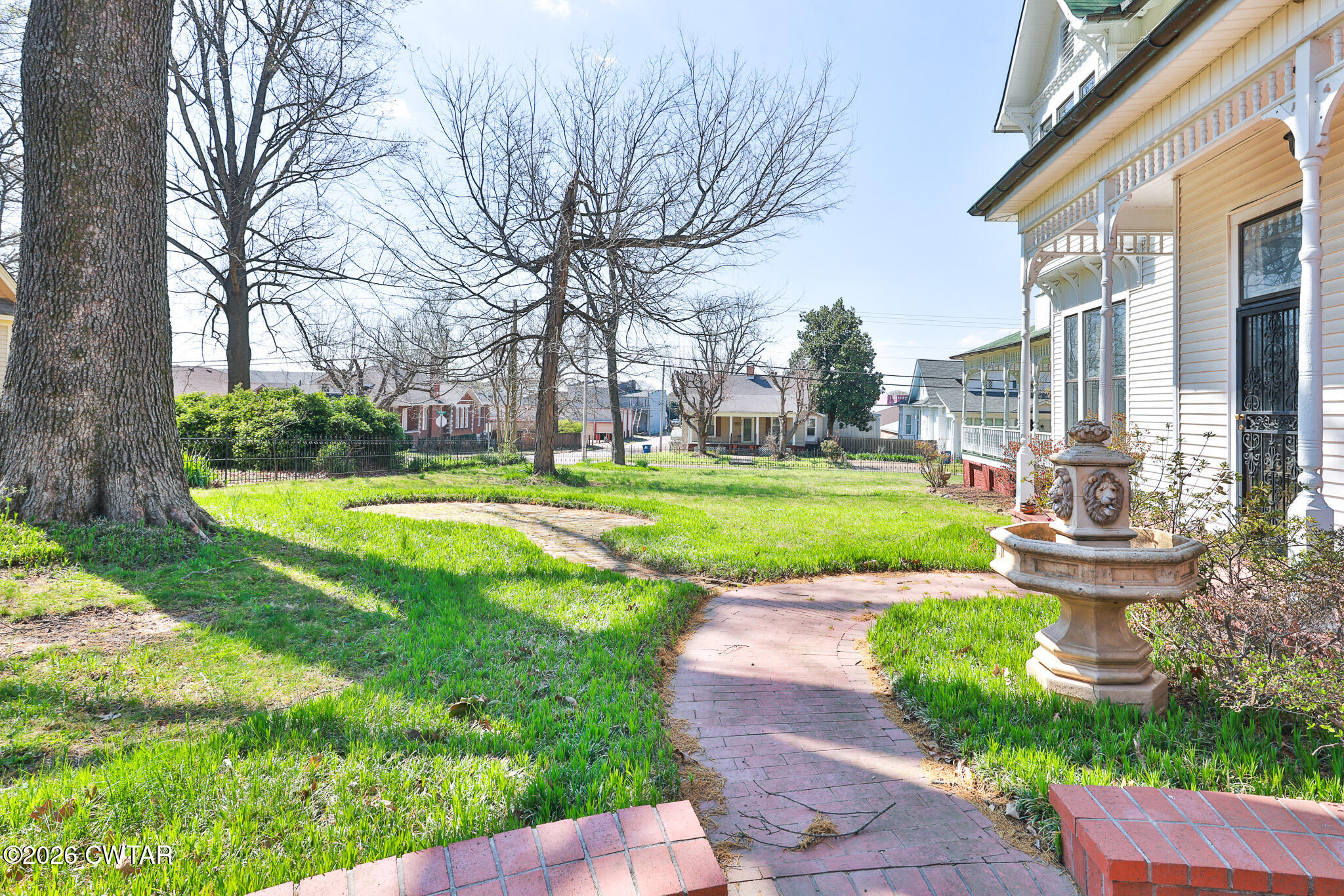 203 North McCombs Street Martin, TN 38237 - Photo 33 of 37 a view of a fountain with a big yard plants and large trees