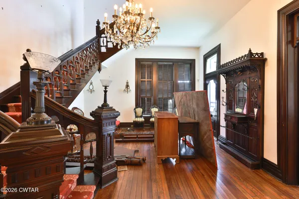 a view of entryway and hall with wooden floor